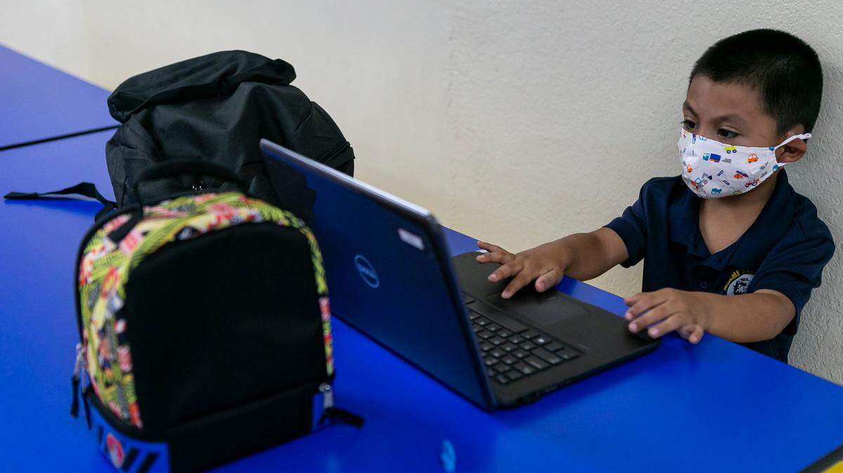 A child attends Miami Community Charter School in Florida City, Fla. for the first day of class on Monday, August 31, 2020. Miami Community Charter is one of the few schools accommodating students who do not have Internet access at home or whose parents cannot stay home with them for remote learning.