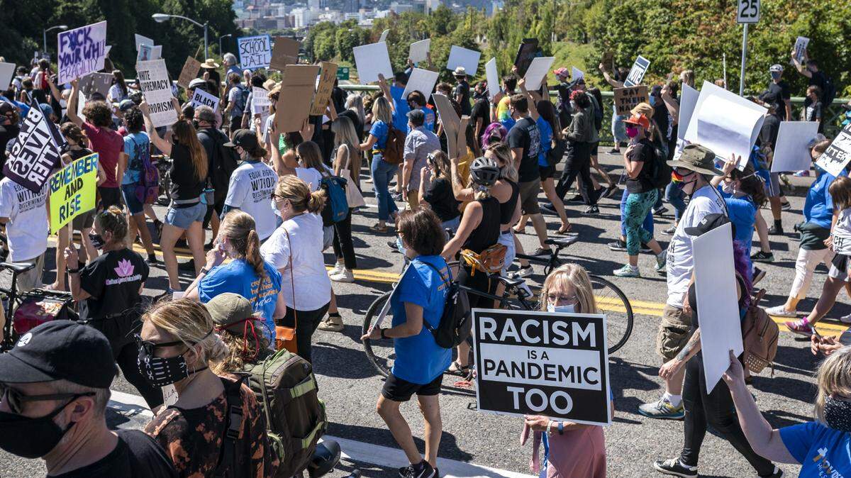 PORTLAND, OR - AUGUST 28: Protesters march through downtown during a Black Lives Matter rally on August 28, 2020 in Portland, Oregon. The protest, organized by the Oregon NAACP, drew many participants as similar Black Lives Matter events took place across the country. (Photo by Nathan Howard/Getty Images)