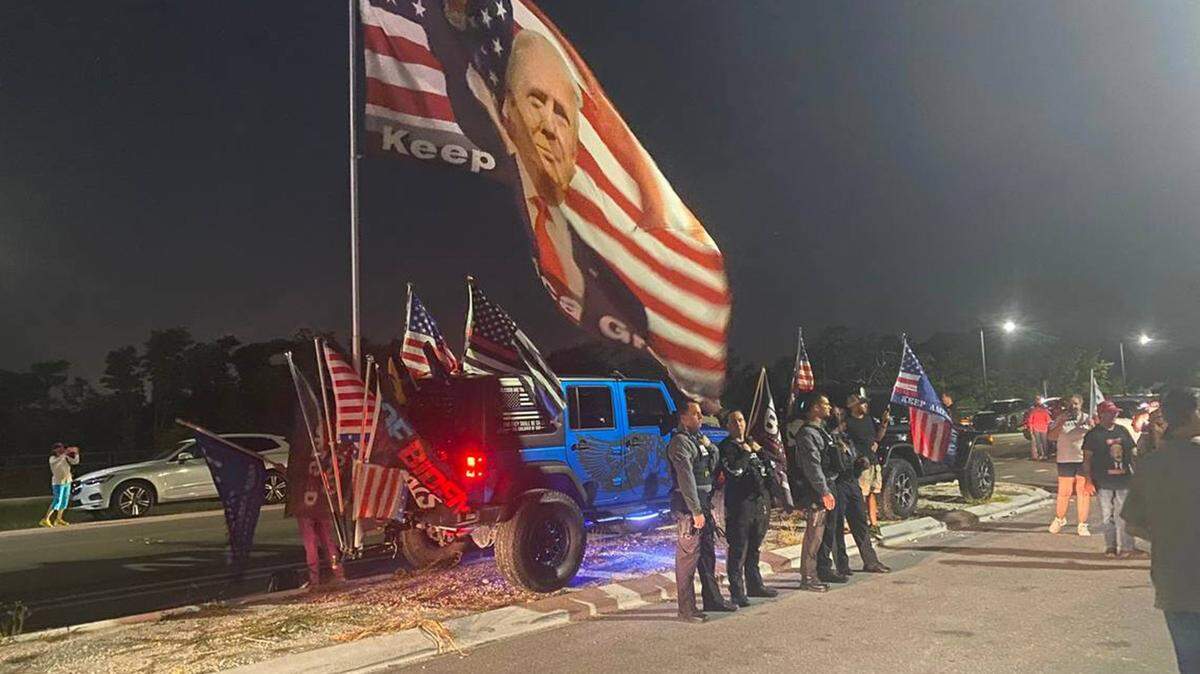 Law enforcement officers observing supporters of former President Donald Trump on Aug. 9, near Mar-a-Lago in Palm Beach, after a search by the FBI.