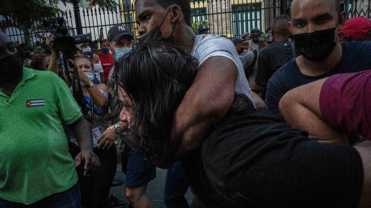 Plainclothes police detain an anti-government protester during a protest in Havana, Cuba, Sunday, July 11, 2021.