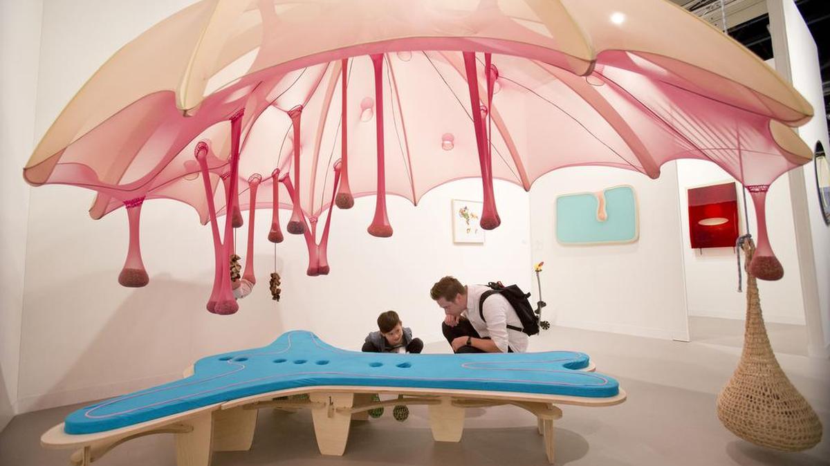 A visitor from New York and his son check out artwork by Ernesto Neto at Art Basel in Miami Beach 2017.