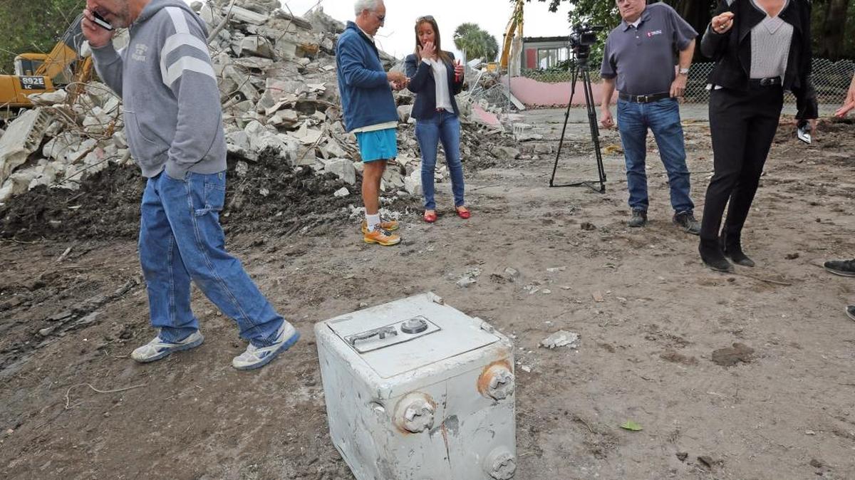 Christian de Berdouare (centro) y su esposa Jennifer Valoppi, propietarios de la antigua mansión del narcotraficante Pablo Escobar en Miami Beach, deciden qué hacer con la caja fuerte encontrada junto a los escombros, el lunes 25 de enero.