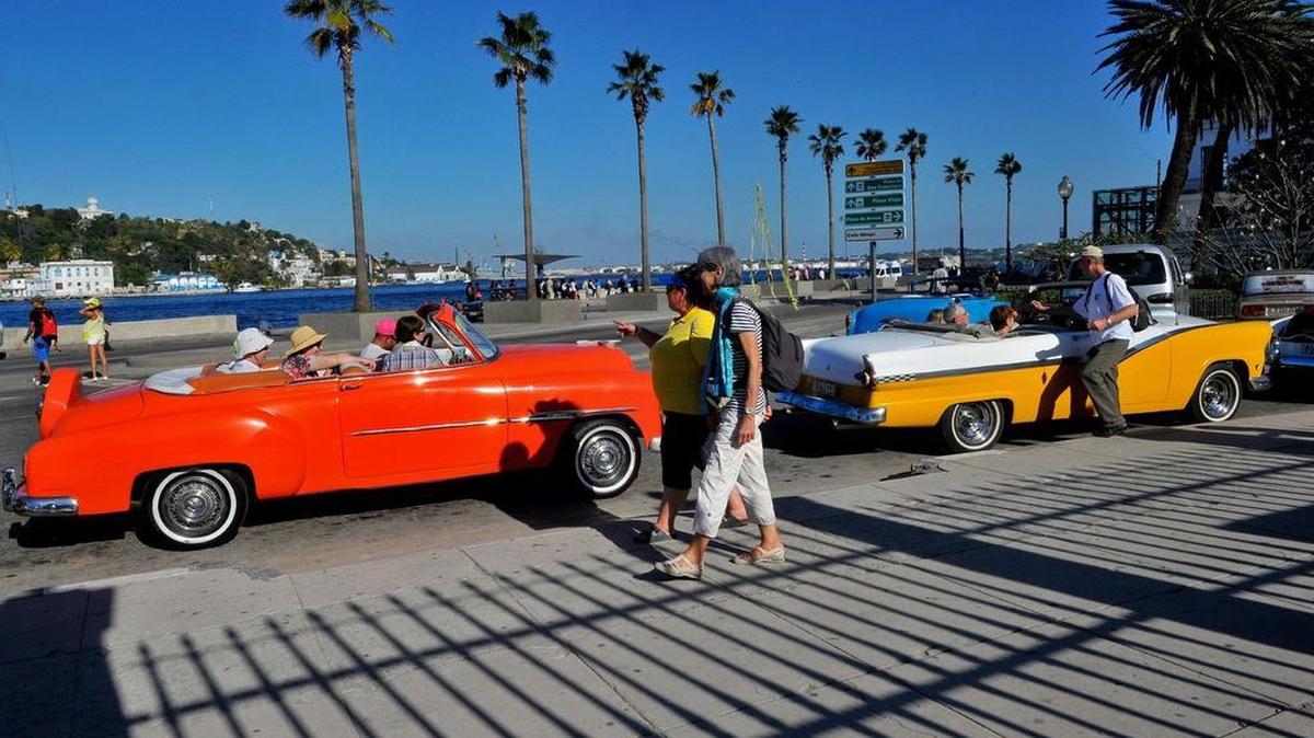 U.S. visitors tour Havana in classic cars in 2015. Since the Trump administration announced new travel rules last fall, the number of Americans visiting the island has fallen off.