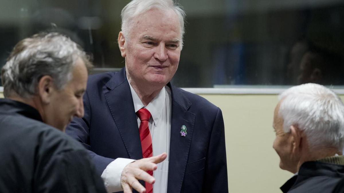 El jefe militar serbio bosnio Ratko Mladic (centro) saluda a miembros de su equipo de defensa en el Tribunal Criminal Internacional en La Haya, en noviembre. Mladic fue sentenciado a cadena perpetua en el juicio por genocidio.