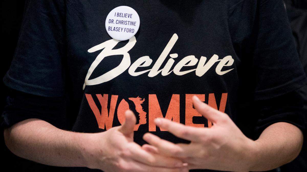 Una mujer con una camiseta que dice “Créanle a las mujeres” (Believe Women) y un botón que dice “Yo le creo a la Dra. Christine Blasey Ford” fue parte de una protesta contra la nominación de Brett Kavanaugh a la Corte Suprema, el lunes frente a la oficina del senador republicano Jeff Flake (Arizona) en Washington D.C.