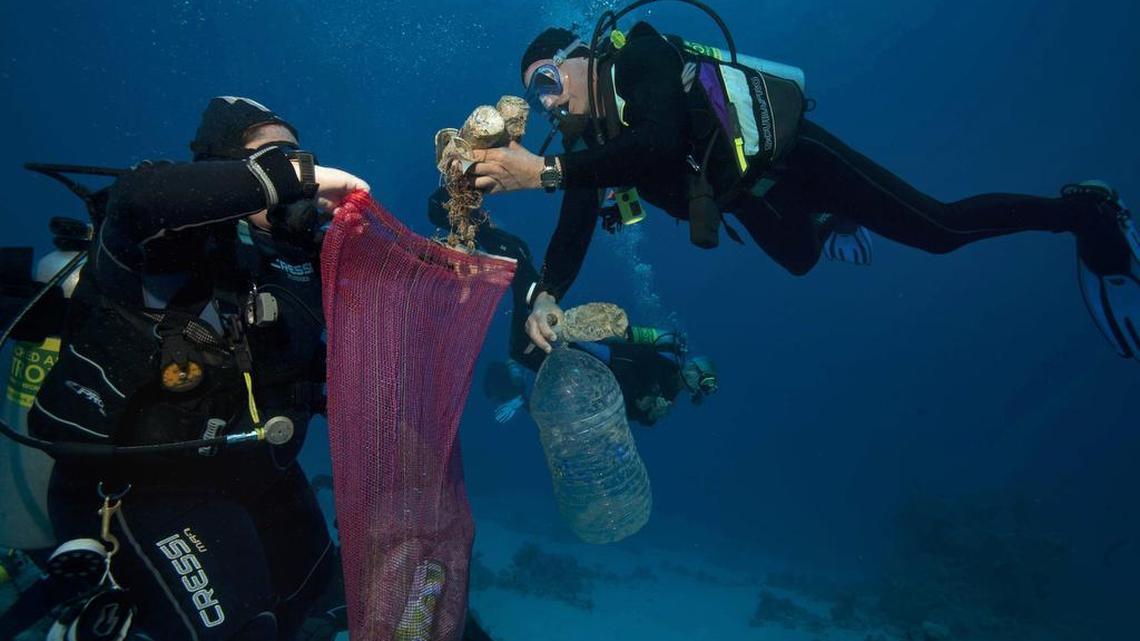 In 2018, divers collect plastic and other debris during a cleanup at a dive site off the coast of the Red Sea resort of Sharm el Sheik, in Southern Sinai, Egypt.