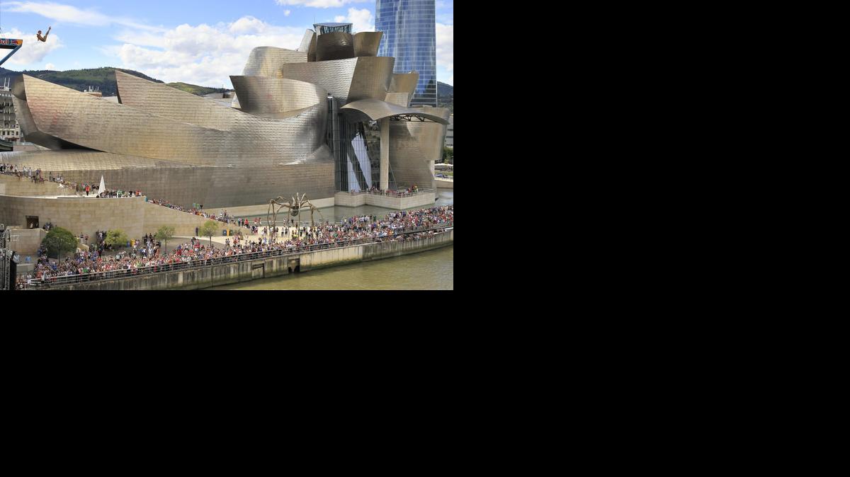 
Un clavadista salta en los primeros entrenamientos de las series mundiales de la Red Bull Cliff Diving, la competencia de saltos acrobáticos más importante del mundo, que se disputará el próximo sábado desde una plataforma de 27 metros de altura en el Puente de La Salve de Bilbao, en el País Vasco. Al fondo el Museo Guggenheim de arte contemporáneo.
