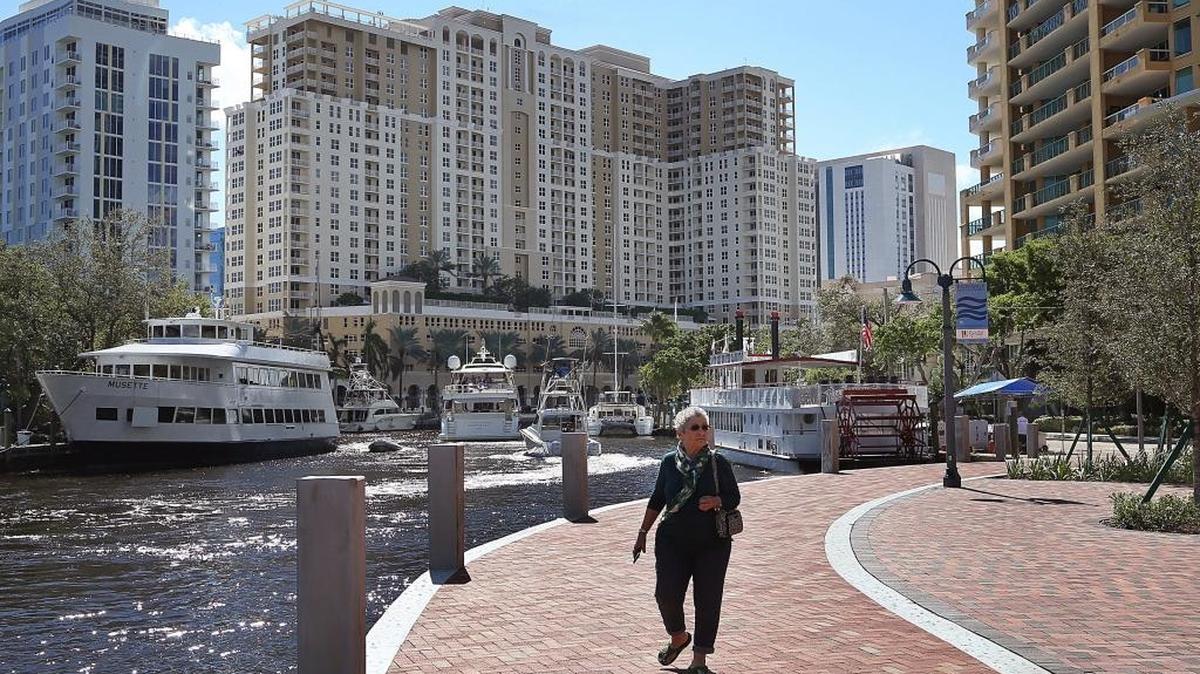 Residential sales dipped last month in Broward County, when comparing activity in 2020 to 2021. Above: A pedestrian strolls the Riverwalk in Fort Lauderdale.