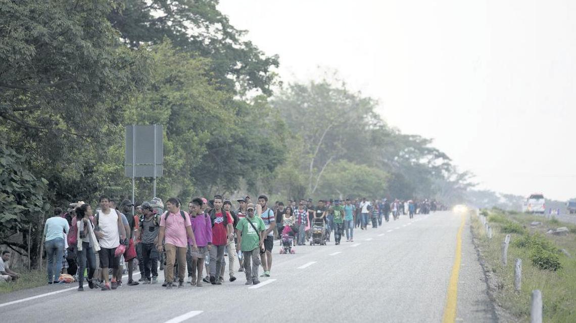 Central American migrants traveling in a caravan to the U.S. border walk on a road in Pijijiapan, Mexico, Monday, April 22, 2019.