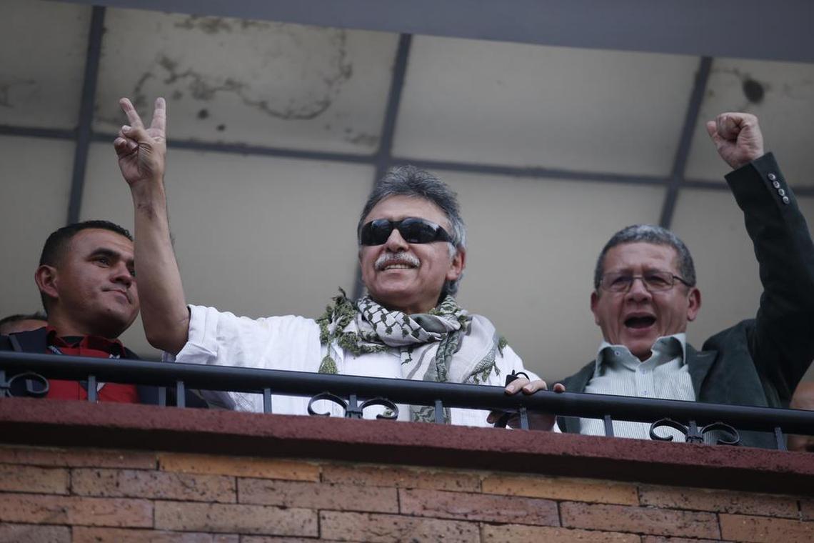 Former rebel leader Seuxis Hernandez, also known as Jesús Santrich, makes the victory sign from a balcony of the FARC party headquarters after he was freed from his second detention in connection with a drug case, as rebel leader Pablo Catatumbo waves, in Bogotá, Colombia, on May 30, 2019. Colombia’s Supreme Court decided that the former FARC peace negotiator, who is accused of conspiring to ship cocaine to the U.S., should be released and determined that his case is part of that court’s jurisdiction because of his post as a legislator.