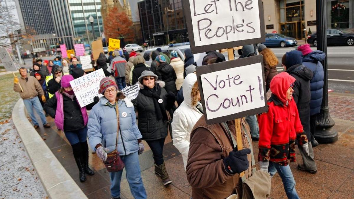 Manifestantes opuestos al presidente electo Donald Trump marchan en Columbus, Ohio, el 19 de diciembre, antes de la votación de los miembros del Colegio Electoral del estado. Los 18 miembros votaron por Trump.