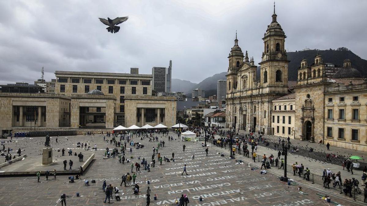 Activistas escriben los nombres de víctimas de la violencia como parte de una exhibición artística en la Plaza de Bolívar, en Bogotá, el 10 de junio de 2019.