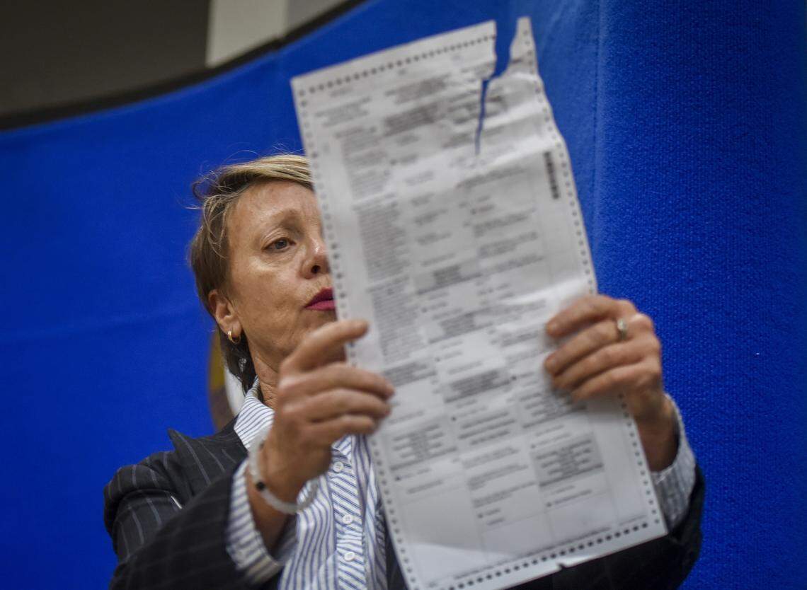 Broward Circuit Judge Betsy Benson, a member of the county’s canvassing board, shows a ballot damaged by tabulating machines on Nov. 14.