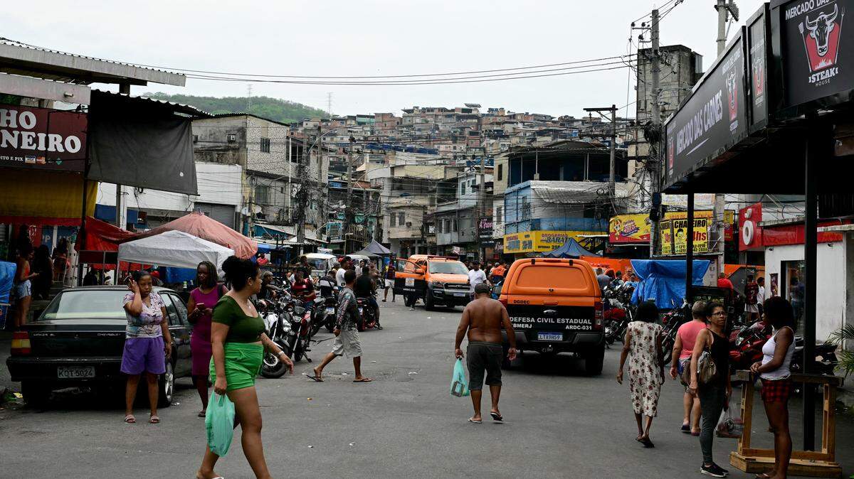Civil Defense vehicles are seen on a street in the Vila Cruzeiro favela at the Penha complex in Rio de Janeiro, Brazil, on October 29, 2025, in the aftermath of Operacao Contencao (Operation Containment). Residents of a favela in Rio de Janeiro lined up more than 50 bodies at a plaza in their low-income neighborhood on Ocotber 29, a day after the bloodiest police operation in the city's history, AFP reported. (Photo by Pablo PORCIUNCULA / AFP) (Photo by PABLO PORCIUNCULA/AFP via Getty Images)