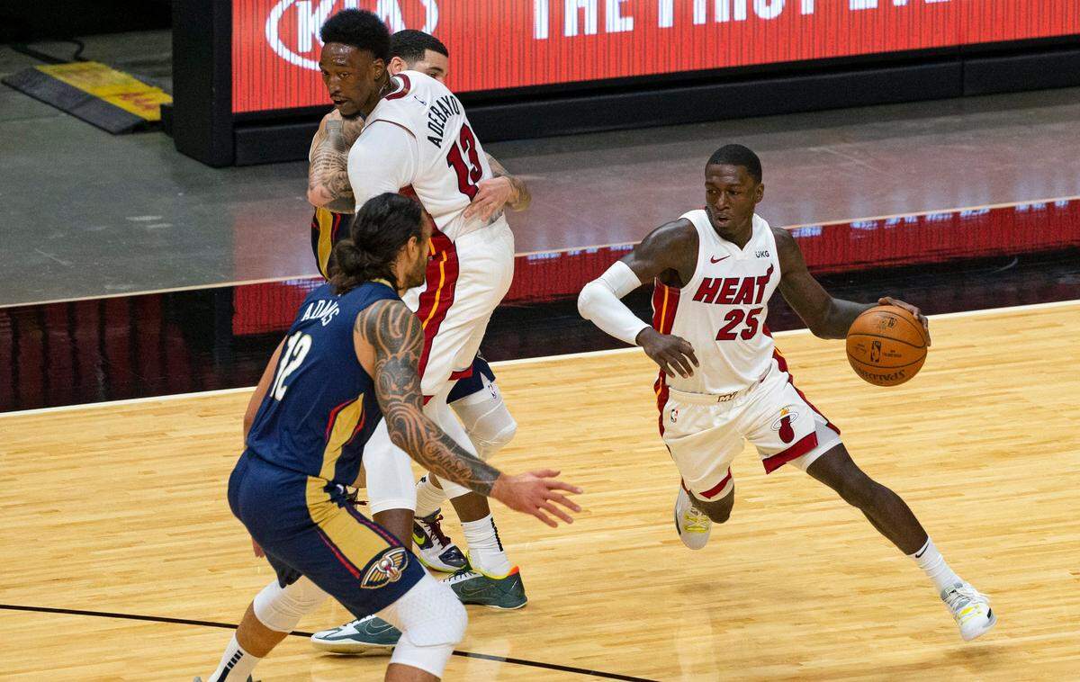 New Orleans Pelicans center Steven Adams (12) defends as Miami Heat guard Kendrick Nunn (25) drives to the basket around a screen by teammate Bam Adebayo (13) in the first quarter of an NBA basketball preseason game at the AmericanAirlines Arena on Monday, December 14, 2020.