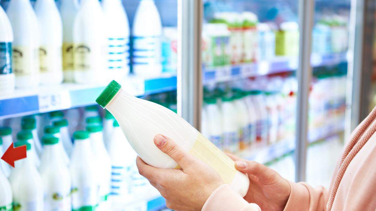 Woman shopping milk in grocery store