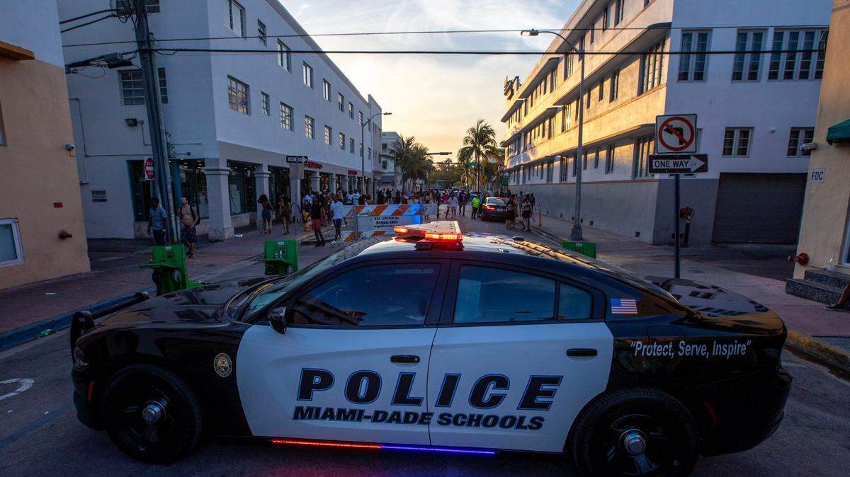 FILE: A Miami-Dade Schools Police car blocks a street off Collins Avenue during Spring Break in Miami Beach, Florida, on Saturday, March 18, 2023.