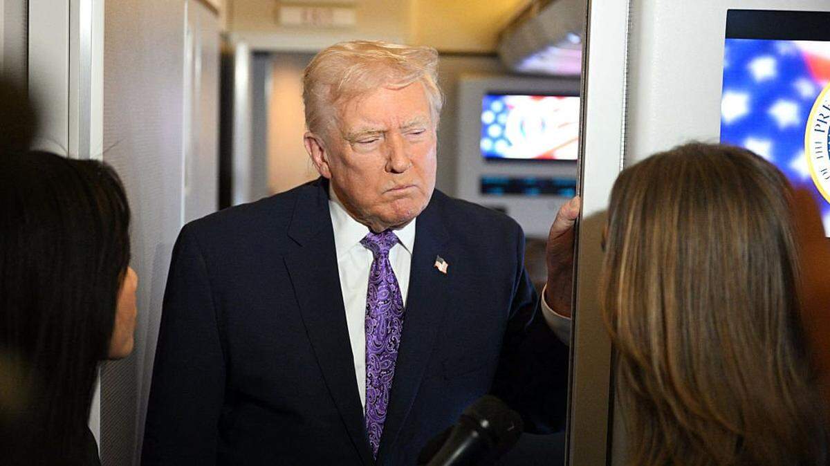 US President Donald Trump speaks to journalists aboard Air Force One while travelling from Palm Beach International Airport to Joint Base Andrews on his return to Washington, DC, on November 30, 2025. President Trump and First Lady Melania Trump spent the Thanksgiving holiday in Mar-a-Lago. (Photo by Jim WATSON / AFP via Getty Images)
