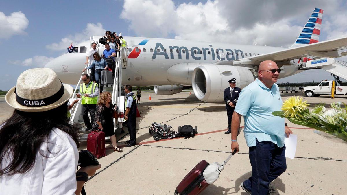 Passengers exit an American Airlines jet on arrival in Cienfuegos, Cuba on the airlines' inaugural flight from Miami to the island on Wednesday, September 7, 2016.