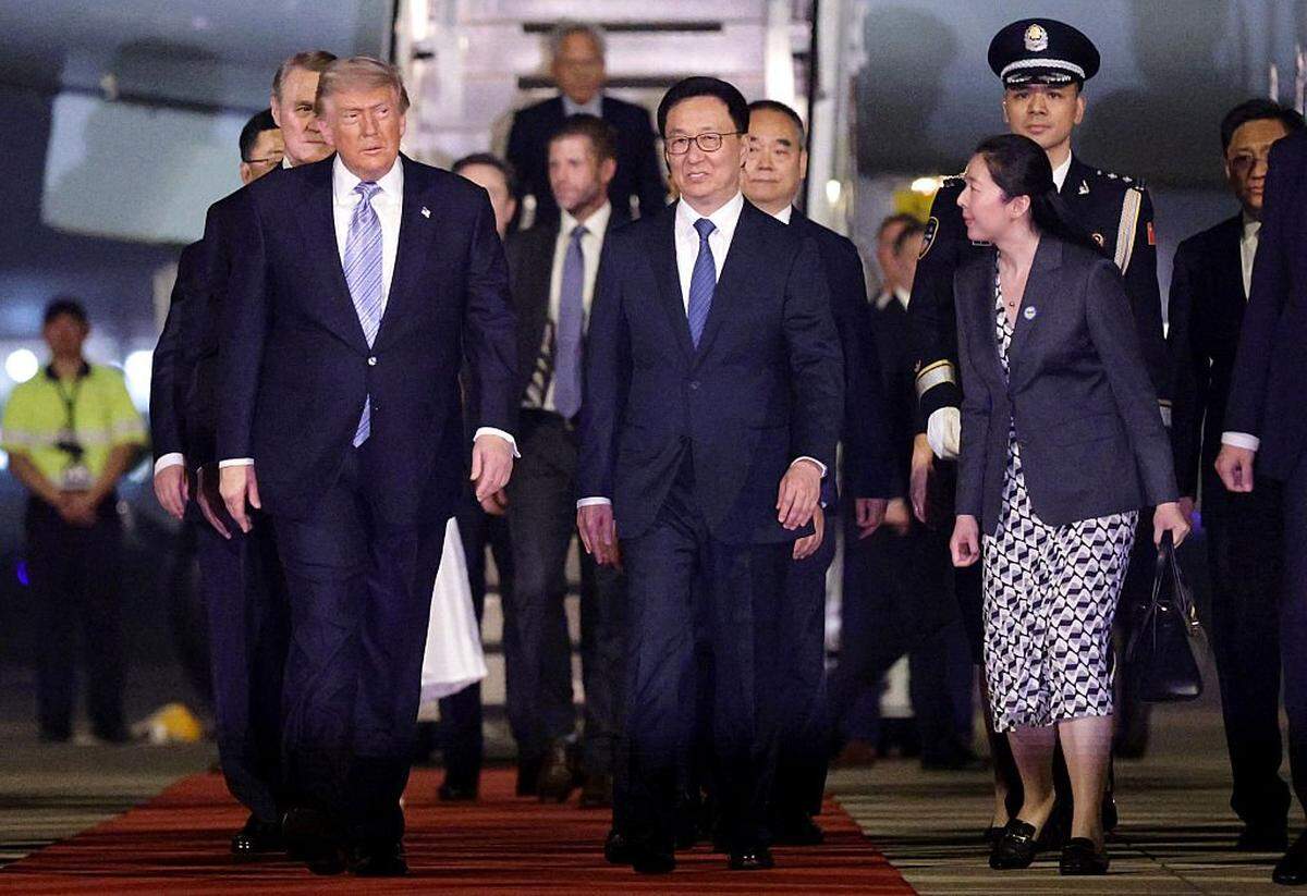 El vicepresidente de China, Han Zheng (c), escolta al presidente de los Estados Unidos, Donald Trump (i), a su llegada al Aeropuerto Internacional de la Capital de Pekín el 13 de mayo de 2026, en Pekín, China.