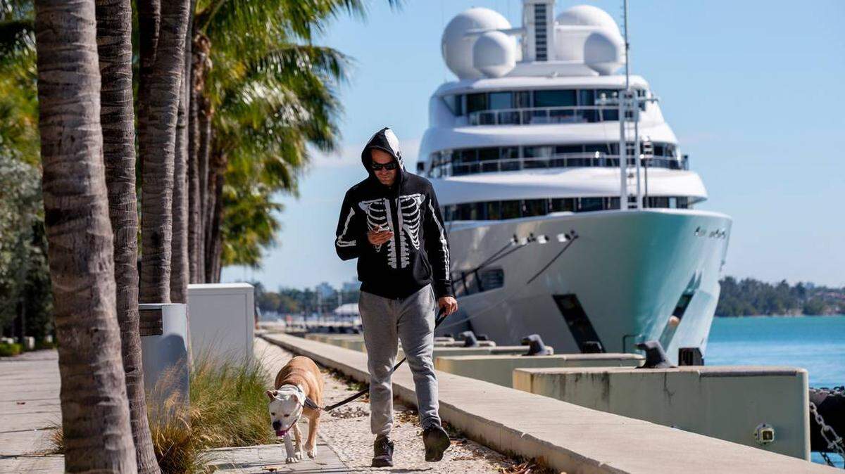 David Gutiérrez, de 39 años, pasea con su perro bajo el frío en el Parque Maurice A. Ferré, en Miami, Florida, el 22 de enero de 2020. 