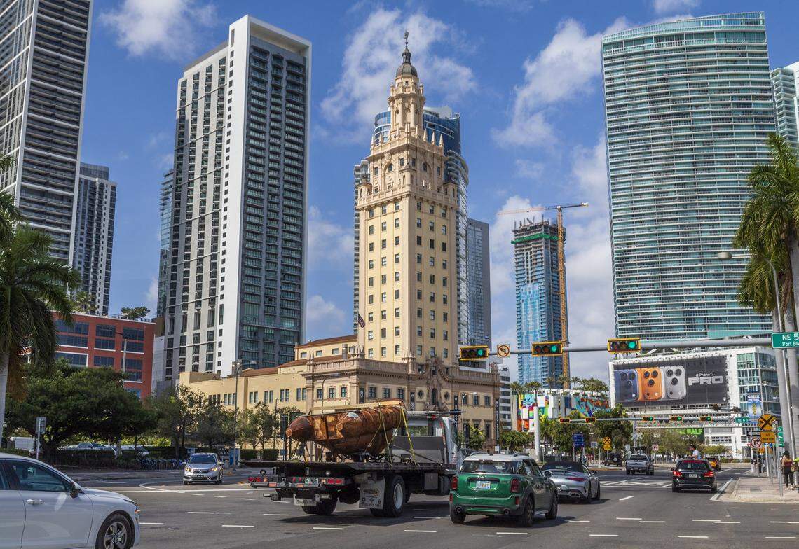 A crane transported the raft from Antonia Wright and Ruben Millares’s studio in Little River to the Piero Atchugarry Gallery in the Design District. It was captured as it passed in front of the iconic Freedom Tower on Biscayne Boulevard.