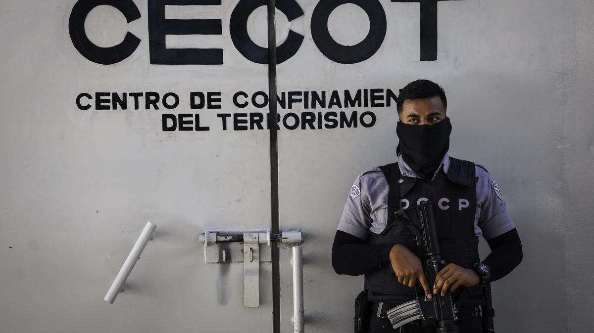 TECOLUCA, EL SALVADOR - DECEMBER 15: A prison guard mans an interior perimeter at CECOT (Counter Terrorism Confinement Center) where thousands of accused gang members are imprisoned on December 15, 2025 in Tecoluca, El Salvador. CECOT gained notoriety in 2025 when the Trump administration began its controversial policy of deporting people to El Salvador who they claimed were members of the Venezuelan criminal organization Tren De Aragua, and Mara Salvatrucha (MS-13), a gang whose members are historically Salvadoran. In 2023 El Salvador opened Latin America's largest prison as part of President Nayib Bukele's plan to fight gangs. The government says some 20,000 gang members are being held at the mega-prison, which has a capacity of 40,000. (Photo by John Moore/Getty Images)(Photo by John Moore/Getty Images)