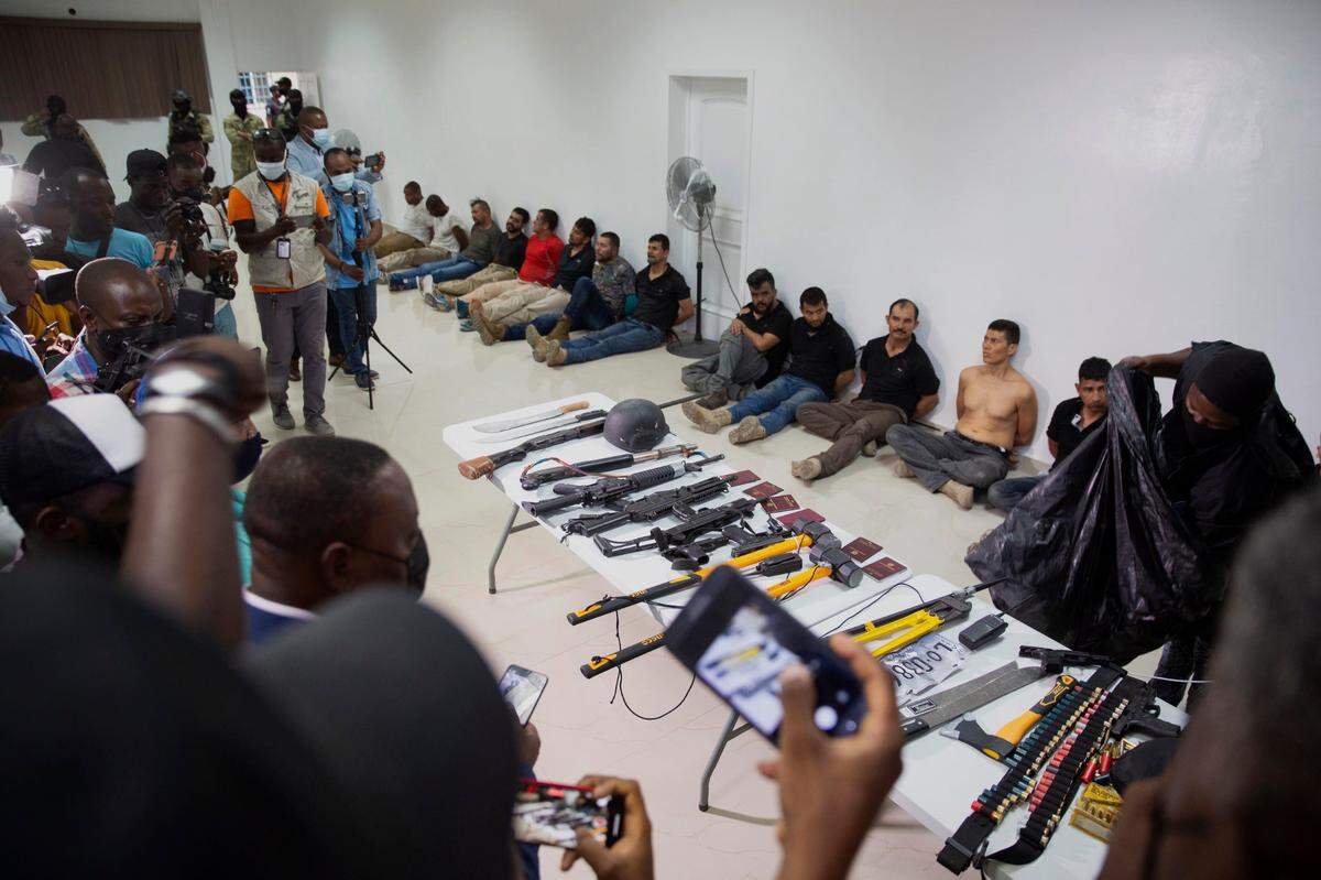 A group of suspects in the assassination of the president of Haiti, Jovenel Moise, are shown to the media together with the weapons and equipment that they allegedly used in the attack, on July 8, 2021 at the General Directorate of the police in Puerto Prince, Haiti.