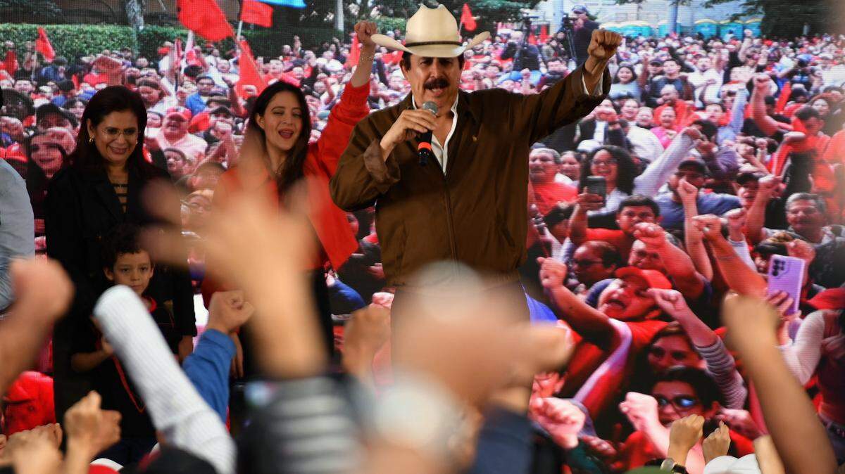 Former Honduran president Manuel Zelaya addresses supporters of the ruling Libertad y Refundacion (LIBRE) party outside the Presidential House during a protest in support of Honduran President Xiomara Castro and against electoral fraud in Tegucigalpa on December 17, 2025. Thousands of supporters of Honduras's outgoing left-wing party staged a demonstration in the capital to protest what they claim is fraud in the presidential elections, with the winner still unknown more than two weeks after the vote. (Photo by Orlando SIERRA / AFP via Getty Images)