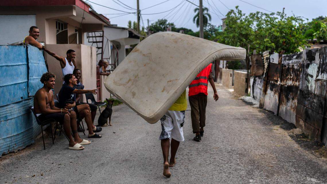 A resident of the El Fanguito neighborhood carries a mattress to a safe place in preparation for the arrival of Hurricane Ian, in Havana, Cuba, Monday, Sept. 26, 2022. Hurricane Ian was growing stronger as it approached the western tip of Cuba on a track to hit the west coast of Florida as a major hurricane as early as Wednesday.