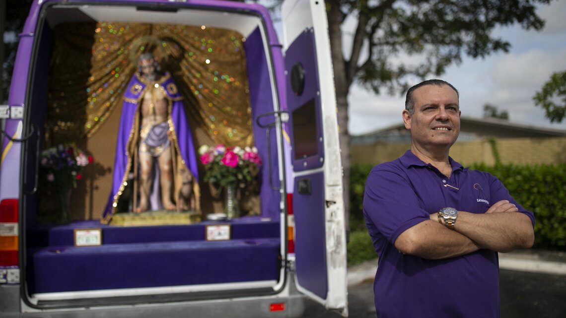 Peek inside this purple van to see a Cuban religious icon traveling to the masses