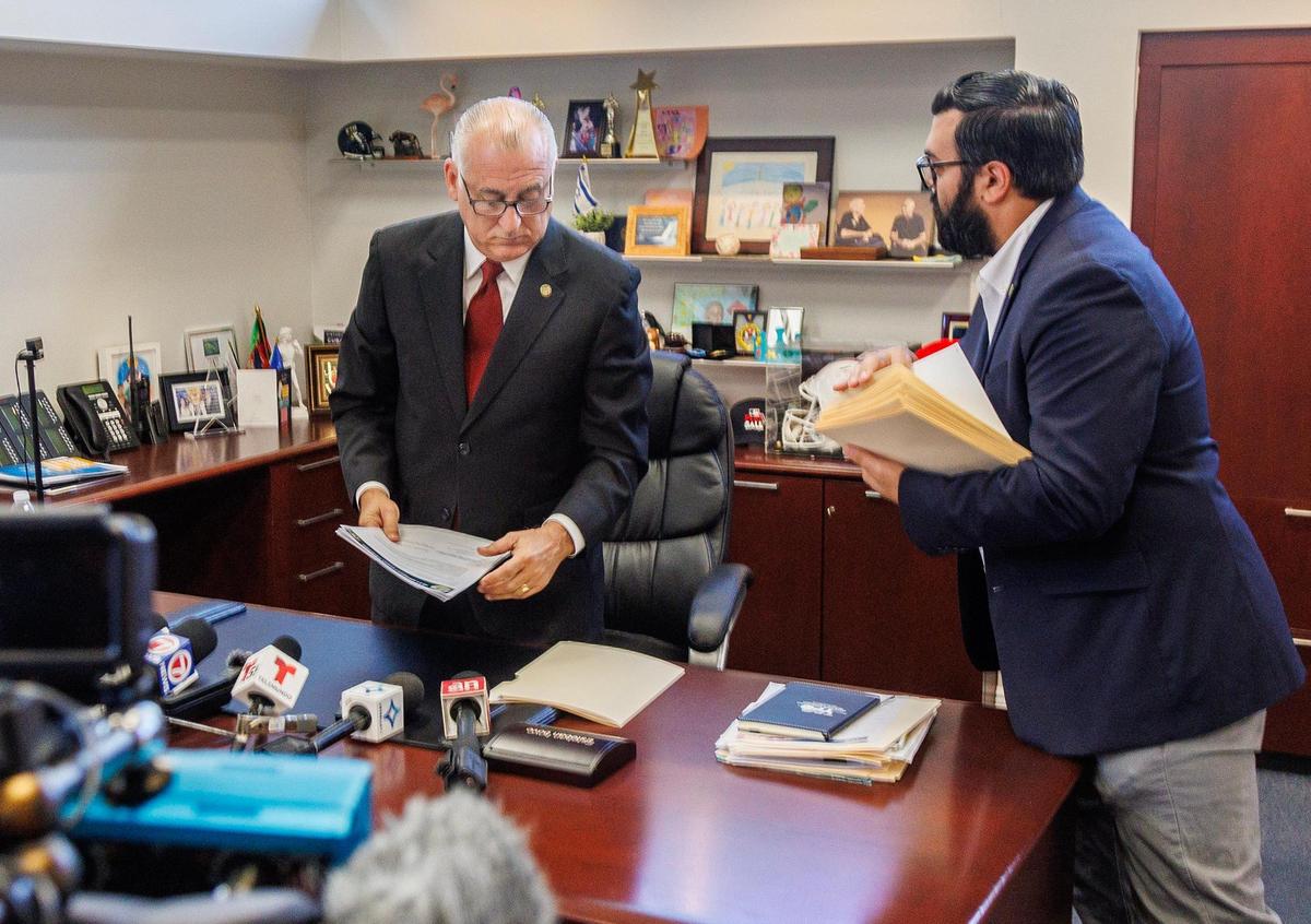 City of Hialeah mayor Esteban Bovo, Jr. talks with his executive assistant Mark Gomez, during a press conference where he talked about the 911issues in the city’s emergency department at city hall, on Thursday, August 10, 2023.