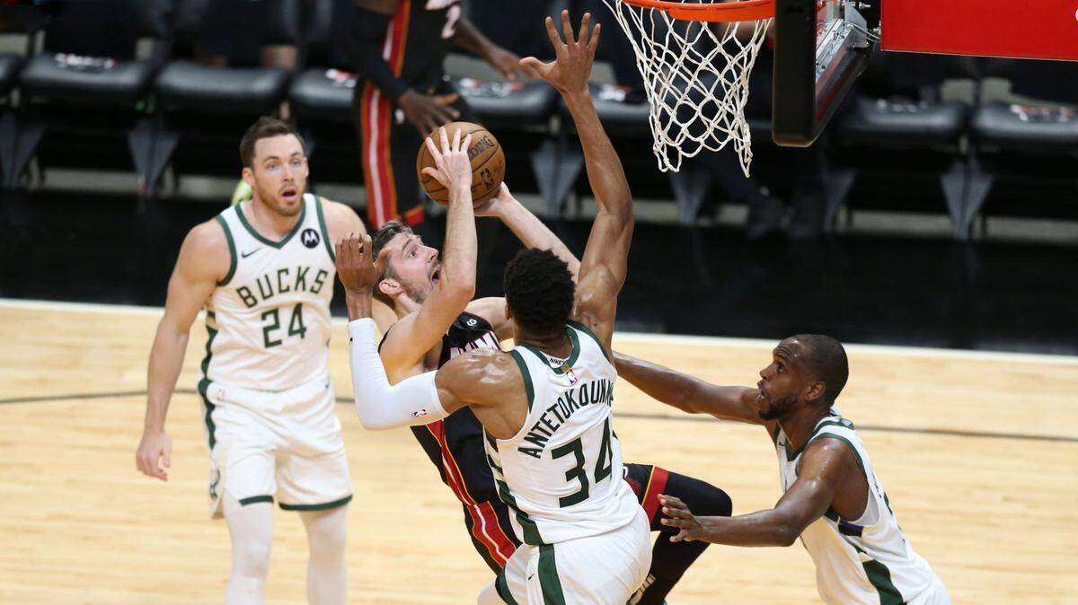 Miami Heat guard Goran Dragic (7) falls back as the Milwaukee Bucks defend the basket in the second quarter during round 1, game 4 of the NBA playoffs at the AmericanAirlines Arena in Miami on Saturday, May 29, 2021.
