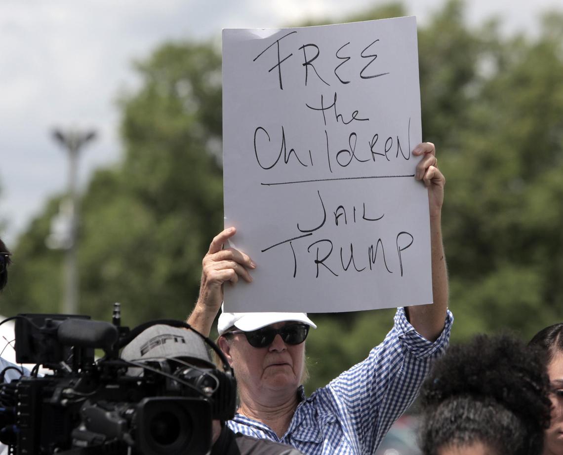 Un manifestante sostiene un letrero que dice en inglés "Liberen a los niños, encarcelen a Trump" durante una conferencia de prensa frente a un centro de detención de menores indocumentados en Homestead, el martes 19 de junio del 2018.