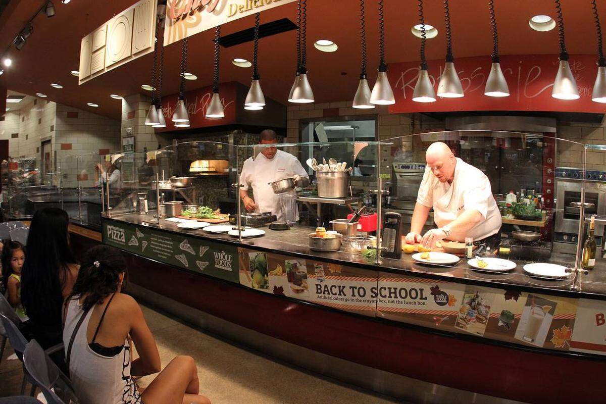Los chefs Timon Balloo y Michael Jacobs cortan platos de pescados y mariscos en el mercado Whole Foods Market, de Coral Gables.