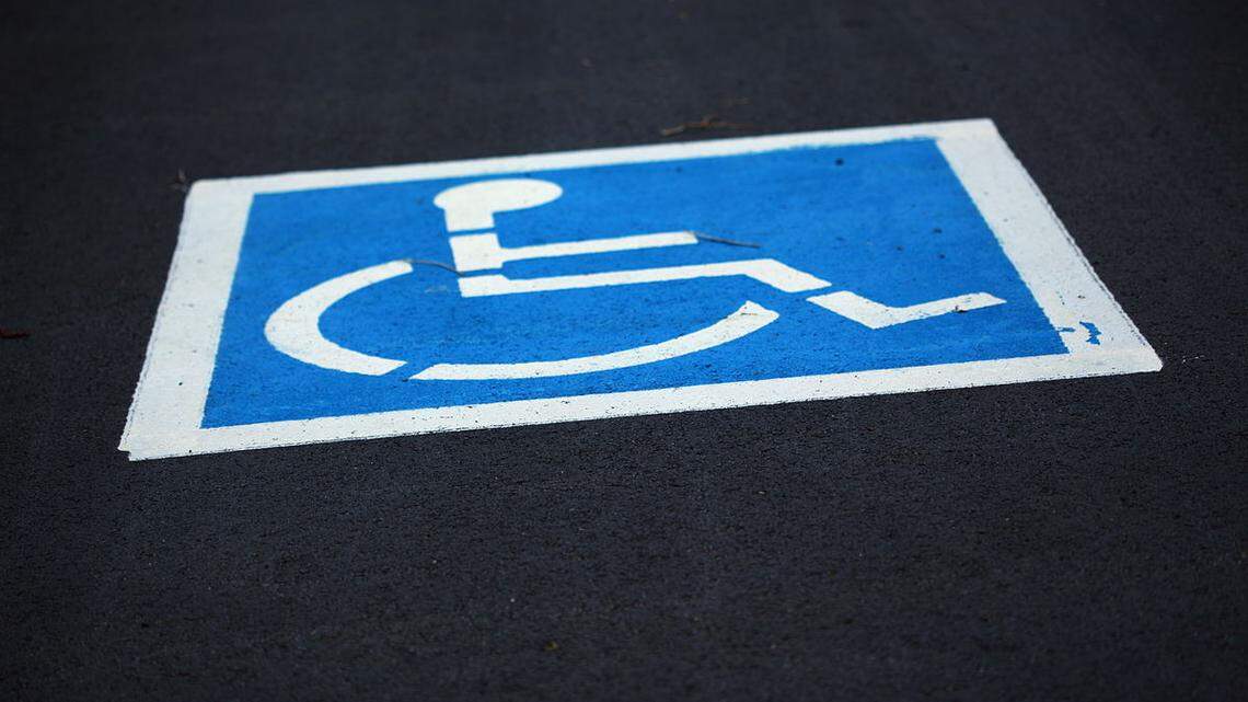 A disabled parking sign is shown. Miami-Dade has launched an audit of all permits issued over the past two years.
