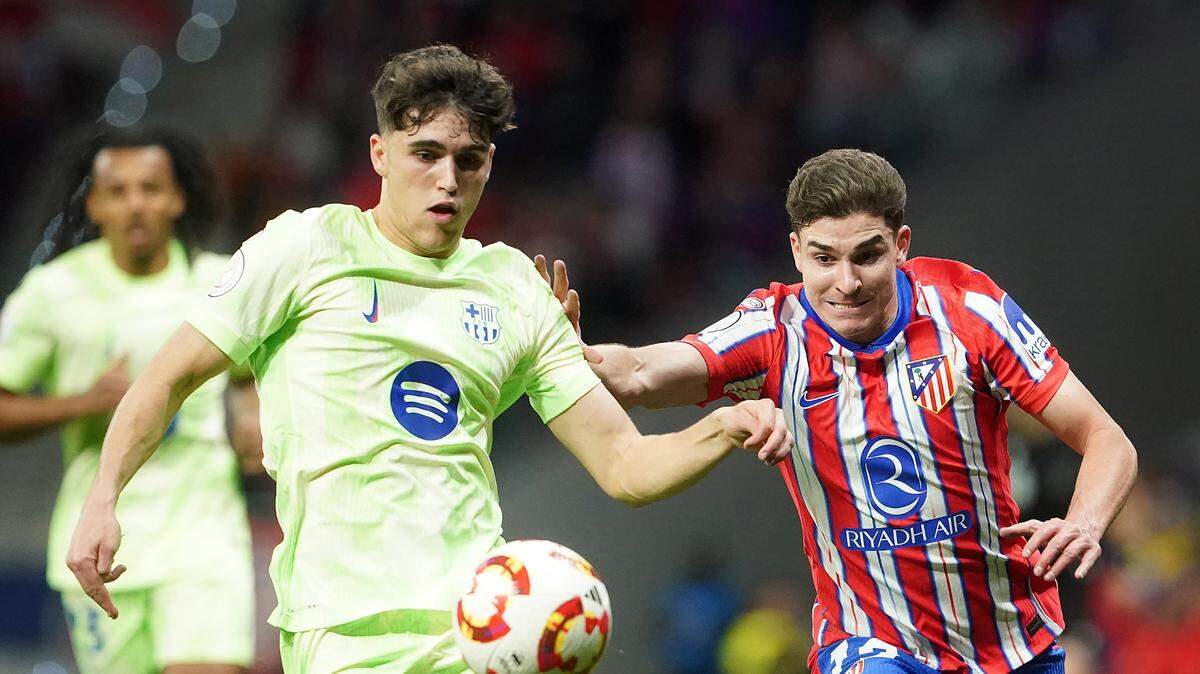 El jugador de Barcelona Pau Cubarsí (izq.) lucha por el balón con el argentino Julian Álvarez, del Atlético de Madrid, en el partido celebrado el 2 de abril de 2025 en el Estadio Metropolitano de la capital española.