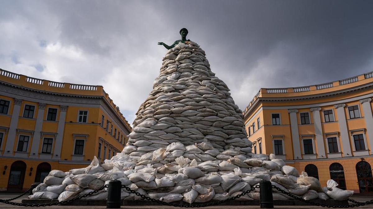 Volunteers in Odessa, Ukraine pile sandbags against Russian attacks.