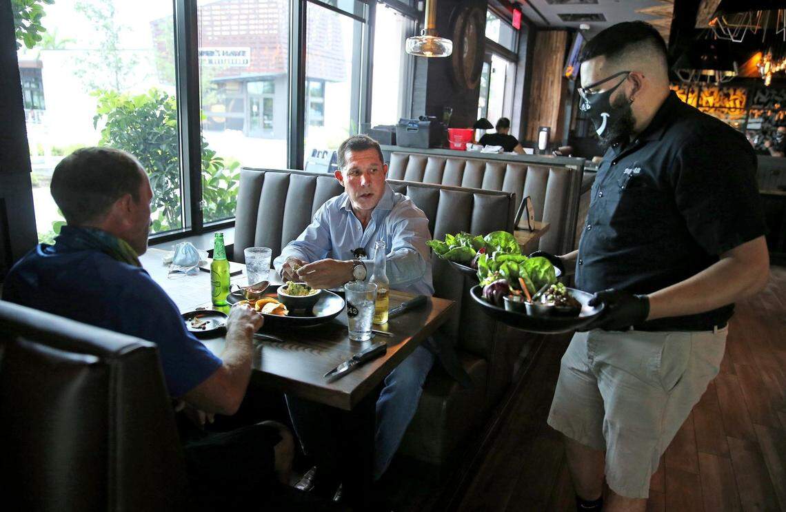 Workers at restaurants throughout South Florida have suffered job losses and reduced hours. Restaurants, including Tap 42 in Doral, were allowed to reopen at limited capacity in May.