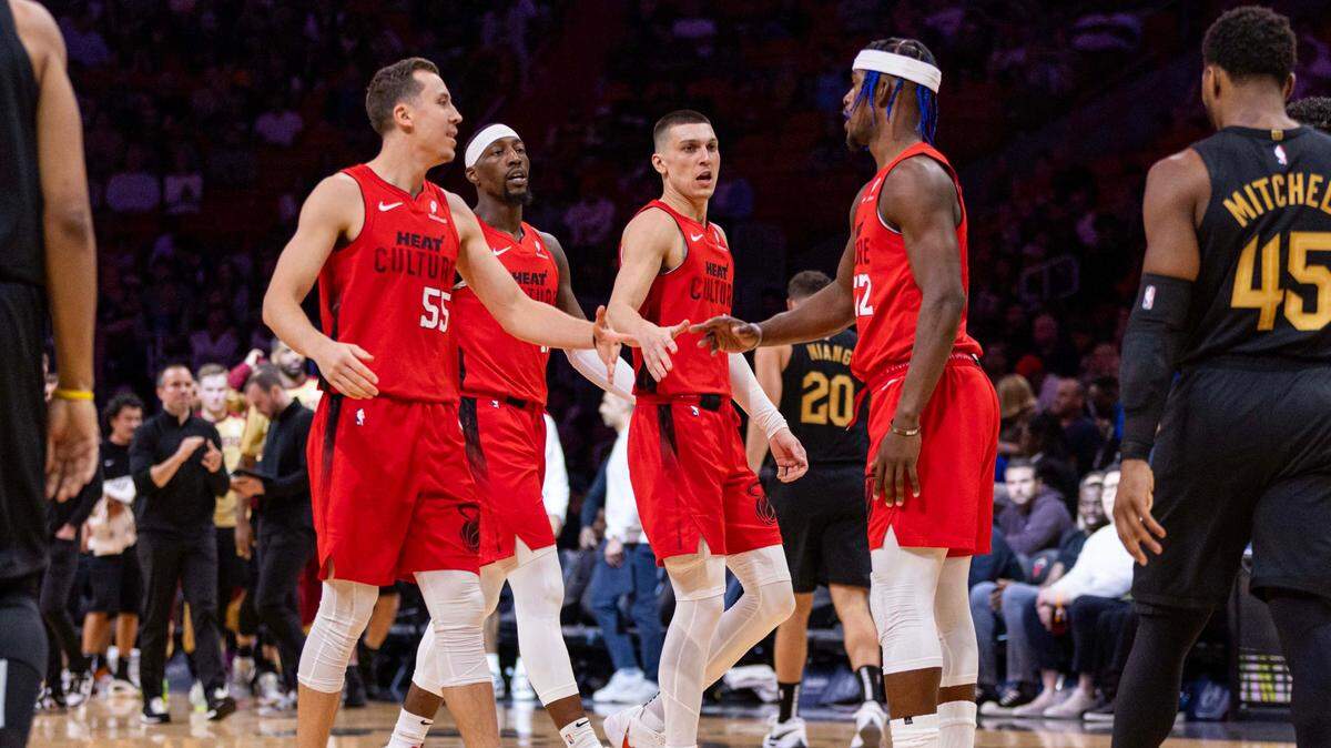 El astro del Heat Jimmy Butler (der.) reacciona con sus compañeros de equipo Duncan Robinson (55), Bam Adebayo (13) y Tyler Herro tras una jugada en el partido contra los Cavaliers de Cleveland, celebrado el 8 de diciembre de 2024 en Miami.
