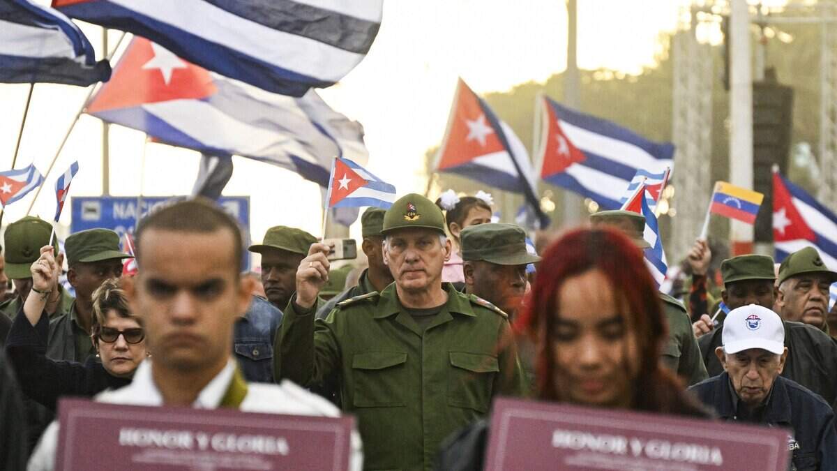 Cuba's President Miguel Diaz-Canel (C) takes part in the "Anti-Imperialist" protest in front of the US Embassy against the US incursion in Venezuela, where 32 Cuban soldiers lost their lives, in Havana on January 16, 2026. The capture by US forces of Venezuelan leader Nicolas Maduro on January 3, 2026, and the killing in the operation of 32 Cubans assigned to protect him represent a major blow for the island's revered intelligence services, experts say. (Photo by YAMIL LAGE / POOL / AFP via Getty Images)