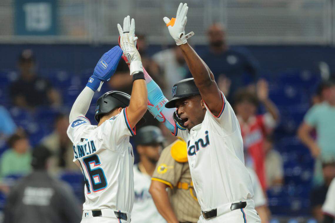 Jul 23, 2025; Miami, Florida, USA; Miami Marlins right fielder Jesus Sanchez (7) celebrates at home plate with center fielder Javier Sanoja (46) after hitting a two-run home run against the San Diego Padres during the fifth inning at loanDepot Park. Mandatory Credit: Sam Navarro-Imagn Images