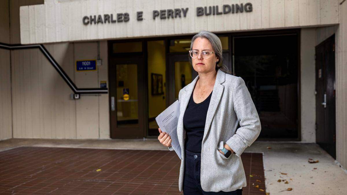 Professor Katie Rainwater stands outside of the Charles E. Perry Building at Florida International University on Tuesday, Nov. 19, 2024, in Miami, Fla. Rainwater is a professor in the Global and Sociocultural Studies department and has spoken out against a state law which is limiting the kinds of courses that can be included in general education with the aim of getting rid of “liberal indoctrination in universities.”, calling it censorship and political meddling.
