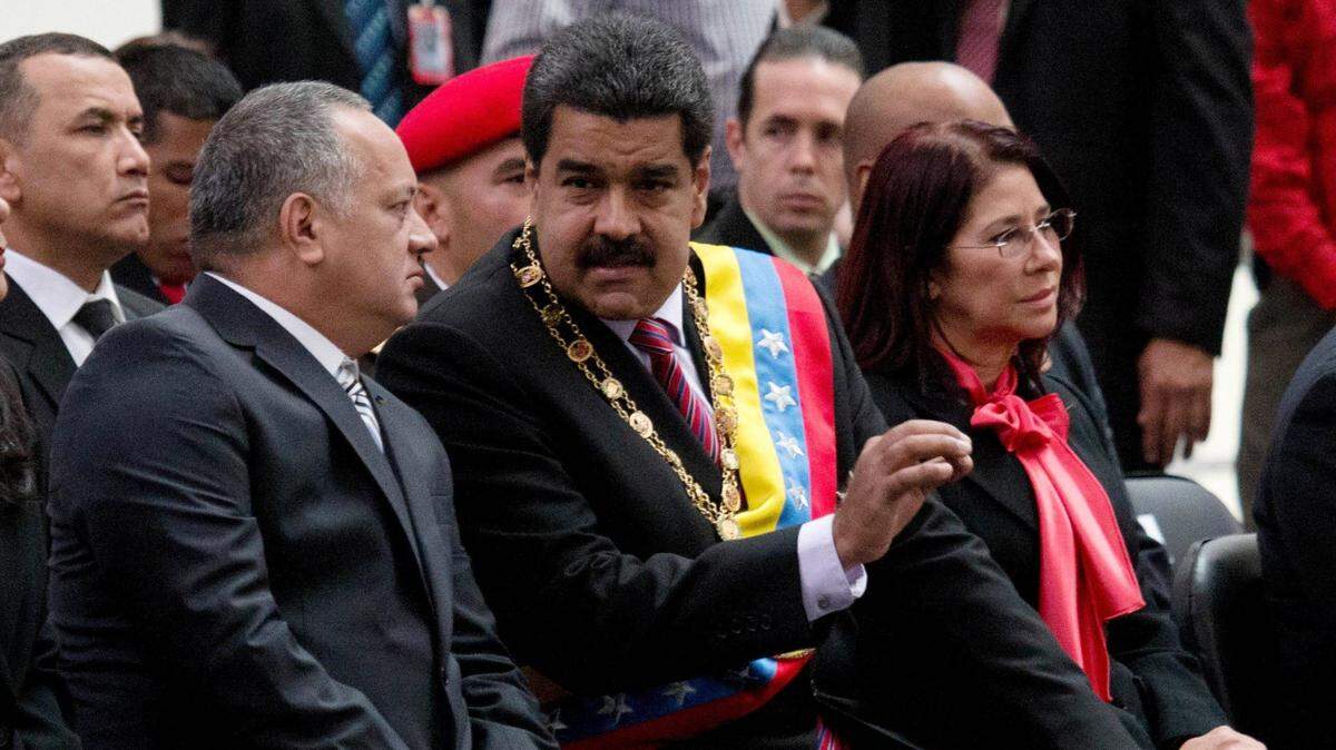 Venezuela's President Nicolas Maduro, center, speaks with National Assembly President Disodado Cabello at a ceremony commemorating the anniversary of the death of independence hero Simon Bolivar in Caracas, Venezuela, Thursday, Dec. 17, 2015.