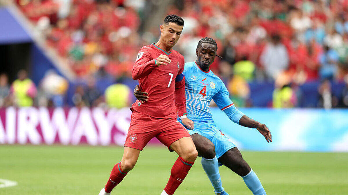 El delantero de Portugal Cristiano Ronaldo (izq.) lucha por la pelota con Axel Tuanzebe, de la República Democrática del Congo, en el partido del Grupo K celebrado el 17 de junio de 2026 en Houston.