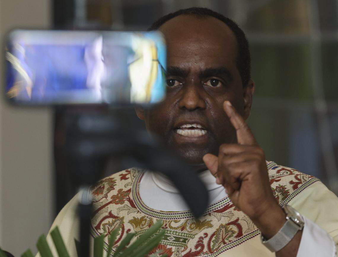 Father Reginald Jean-Mary holds Mass inside the small chapel at Notre Dame d’Haiti Church in Miami as houses of worship closed their doors but telecast their Sunday Easter services via social media on April 12, 2020. Large social and religious gatherings were prohibited due to shelter-in-place mandates by local and state governments due to the coronavirus pandemic.