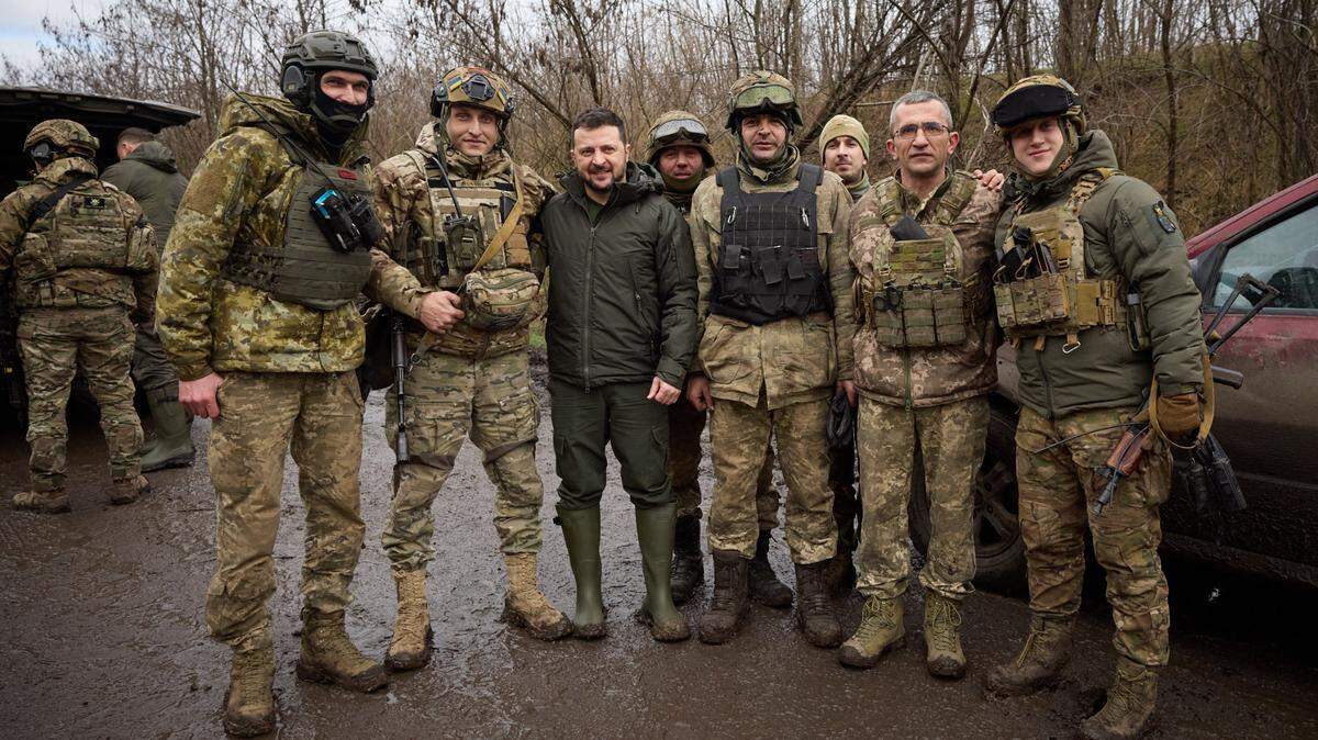 Ukrainian President Volodymyr Zelensky poses with military personnel during his visit to the Zaporizhzhia region in February.