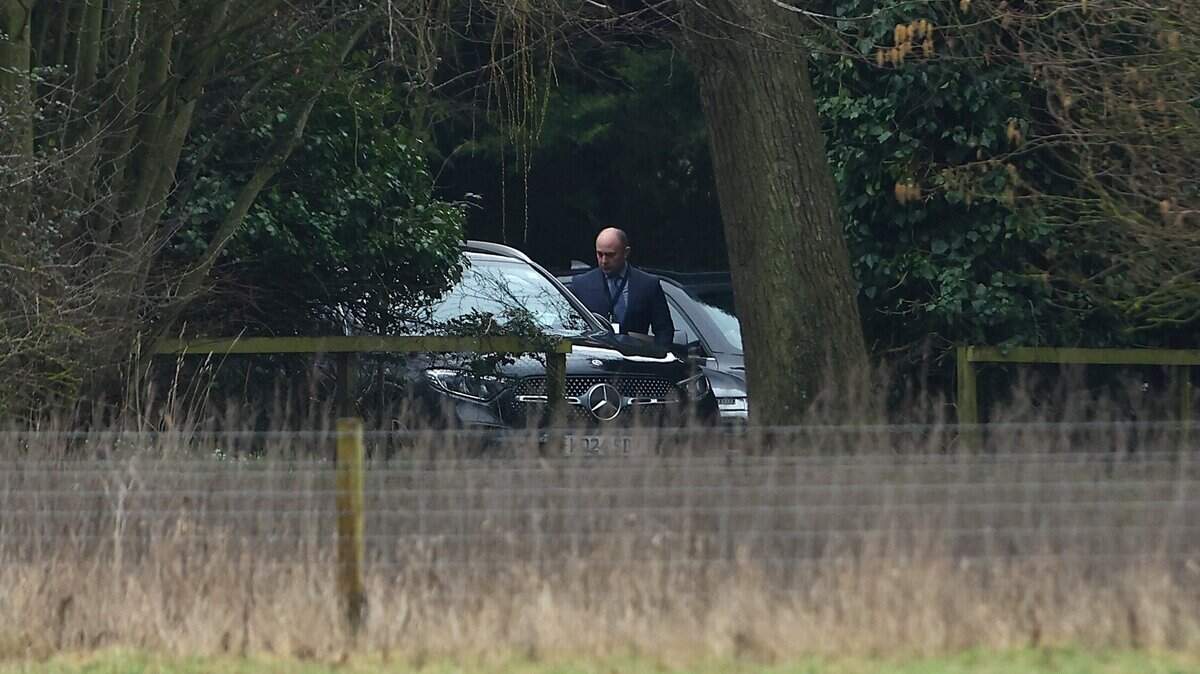 SANDRINGHAM, NORFOLK - FEBRUARY 19: A man steps out of umarked car at the home of Andrew Mountbatten-Windsor on February 19, 2026 in Sandringham, Norfolk. Andrew Mounbatten-Windsor has been arrested on suspicion of misconduct in public office, following police investigation into the recently release Epstein files. The former prince continues to deny any wrongdoing. (Photo by Peter Nicholls/Getty Images)