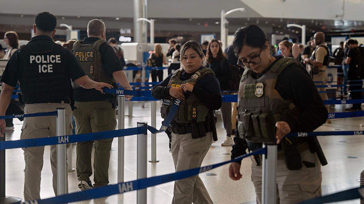 HOUSTON, TEXAS - MARCH 28: ICE agents enter the security line at George Bush Intercontinental Airport on March 28, 2026 in Houston, Texas. After House Republicans rejected a Senate-passed deal to fund Department of Homeland Security (DHS) subagencies including the Transportation Security Administration (TSA), President Trump issued an executive order on Friday instructing DHS to immediately pay TSA agents who have been working without pay for over 40 days. (Photo by Danielle Villasana/Getty Images)
