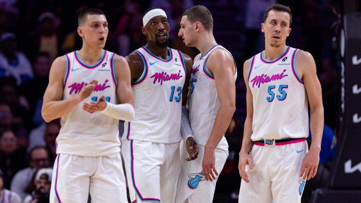 Miami Heat players Tyler Herro (14), Bam Adebayo (13), Nikola Jovic (5) and Duncan Robinson (55) react to a play during the second half of an NBA game against the Orlando Magic at the Kaseya Center on Monday, January 27, 2025, in Miami, Fla.